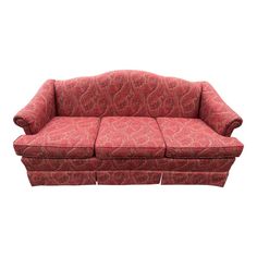 a red couch sitting on top of a white floor