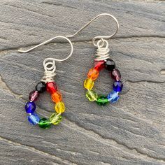 Rainbow dangle drop earrings, made with Czech fire polish glass beads, 4mm rounds, in a rainbow of colors on sterling silver wire.red - orange - yellow - olive green - emerald green - light blue - dark blue - amethyst purple - blackMeasure just under 1 1/2 inches in length, from top of sterling earwire to bottom of earring. Width is 1/2 inch at widest point. ~~~~~~~~~~~~~~~~~~~~~~~~~~~~~Artisan Crafted. All of my items, whether jewelry or decorative works, have been handcrafted by me, one person Rainbow Sterling Silver Jewelry With Ear Wire, Adjustable Rainbow Sterling Silver Earrings, Hypoallergenic Rainbow Drop Earrings, Rainbow Nickel-free Drop Earrings, Rainbow Sterling Silver Nickel-free Earrings, Rainbow Dangle Jewelry For Everyday, Nickel-free Rainbow Drop Earrings, Rainbow Wire Wrapped Round Jewelry, Rainbow Sterling Silver Earrings