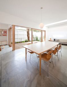 a dining room table and chairs in front of sliding glass doors