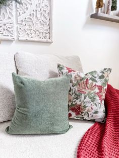 the pillows on the bed are all different colors and patterns, but one is green