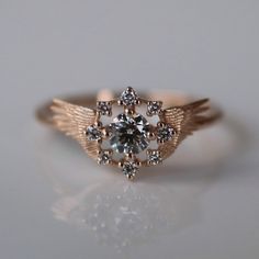 Inspired by Priests from online role-playing games like World of Warcraft, the center diamond in this ring is surrounded by a sparkling halo and intricate golden angel wings. CUSTOMIZE GEMSTONES ✶ solid 14 karat yellow, white, or rose gold✶ band measures 1.6mm wide x 1.4mm thick✶ center stone: 0.25 ct. VS-SI clarity round brilliant cut diamond✶ accent stones: 0.09 tcw. VS clarity round brilliant cut lab-grown diamondsThis ring will be handmade just for you.Please allow 4-6 weeks production time Handmade Vintage Style Ring, Mexican Wedding Rings, Golden Angel Wings, Golden Angel, Cute Engagement Rings, Rococo Style, Jewelry Lookbook, Style Aesthetic, Pretty Rings