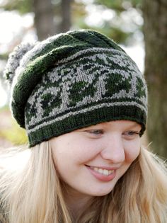 a woman wearing a green and white knitted hat