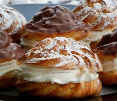 several pastries with chocolate frosting and powdered sugar