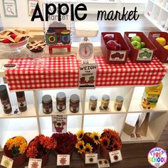 an apple market display with apples and flowers