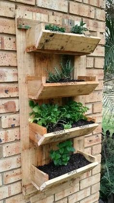 three wooden shelves filled with plants on top of a brick wall next to a planter