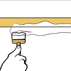 a hand holding a paintbrush over a white wall with gold trim and yellow border