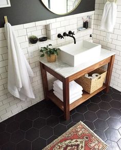 a bathroom with a sink, mirror and rug