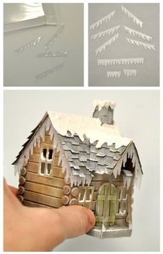 the paper house is cut out to look like it has snow on top