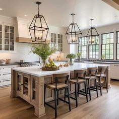 a large kitchen with an island in the middle and lots of counter space on one side