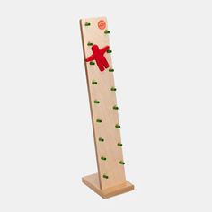 a wooden ruler with green dots and a red bear on it's back side