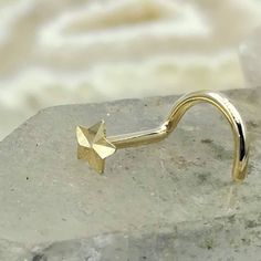 "Nose ring stud, 14K solid yellow gold star. Available in 20 or 18 gauge. Available as a nose ring, tragus or cartilage earring. Star size 3mm. Nose ring - \"L\" post, screw back right or screw back left post. . Cartilage earring - 11mm post with butterfly and silicone backings. Follow us on: Instagram @sampsonjewelry Facebook @sampsonjewelry Pinterest @sampsonjewelry Tweet on Twitter @sampsonjewelry To save for later, click Add Item to Favorite With any questions or comments feel free to convo Gold Internally Threaded Ring As Gift, Yellow Gold Internally Threaded Rings For Gift, Nose Ring Designs, Earring Star, L Post, Gold Nose Ring, Ear Lobe Piercings, Gold Nose Stud, Gold Nose Rings