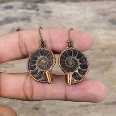 Note : Due to the natural formation of this gemstone. Slight variation in design and color are to be expected.  Ammonite Fossil Earring Electroformed Copper Earrings Amazing Earring Electroformed Jewelry Handmade Dainty Gemstone Earring Engagement Gift Handmade Electroformed Copper Earrings SKU : VZE-57 Gemstone : Ammonite Fossil Metal Purity : Copper Earrings Length : 45 MM   Earrings Width : 25 MM Ammonite fossils are believed to help with ailments like blood pressure and degenerative disorder Nature-inspired Copper Earrings As Gift, Nature-inspired Electroformed Brass Earrings, Bronze Spiral Earrings For Gifts, Nature-inspired Bronze Earrings For Gifts, Electroformed Dangle Earrings For Gifts, Electroformed Drop Earrings Gift, Unique Wedding Earrings, Ammonite Jewelry, Fossil Earrings