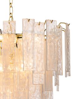 a large chandelier made out of glass blocks and brass fittings, hanging from a chain