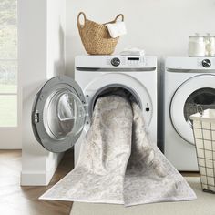 a washer and dryer sitting next to each other in a room