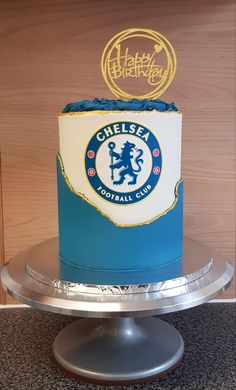 there is a blue and white cake with a chelsea logo on it that says happy birthday