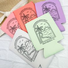 four beach themed coasters sitting on top of a white bed next to a straw hat