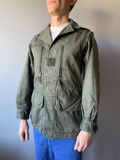 French Work Jacket / Bleu de travail / French Workwear / French Chore Coat / French Army Combat Jacket F2 / Size S This vintage French military jacket in good used condition! - made in France - ERA - 1970's - color - gray / green - 4 outside pockets  - 2 buttons on the cuff - 6 buttons at front - material - cotton - label size - 88C (fit S) (watch measurements) FLAT Measurements: Shoulders: 42cm Chest (underarm to underarm): 47cm Sleeve: 58cm Length(back): 75cm Model height and weight reference (cm/kg): 176/68 Pay your attention to that  most antique items have been used and may have minor flaws. Please , read the description carefully and check the measurements! SHIPPING: UkrPosta Airmail Shipping: - Europe: 23$ - 14-31 days (No shipping to Germany!) - United Kingdom: 23$ - 14-31 days  - Military Style Long Sleeve Utility Jacket With Pockets, Long Sleeve Military Utility Jacket With Pockets, Military Style Utility Jacket With Pockets, Military Style Outerwear With Patch Pockets, Military Style Long Sleeve Windbreaker With Pockets, Military Style Utility Jacket With Multiple Pockets, Military Utility Jacket With Patch Pockets, Military Utility Jacket With Multiple Pockets, Military Style Parka With Cargo Pockets And Long Sleeves