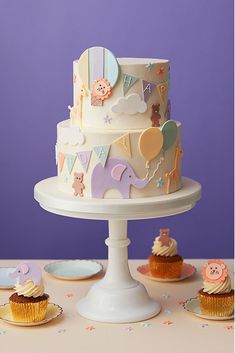 three different types of cakes and cupcakes on a cake platter, with the words baby cakes below them