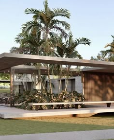 a modern house with palm trees in the background