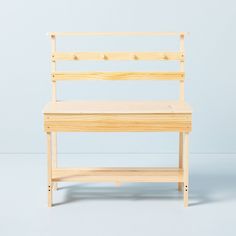 a wooden bench sitting on top of a white floor next to a blue wall in an empty room