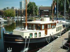 a boat is docked in the water near other boats