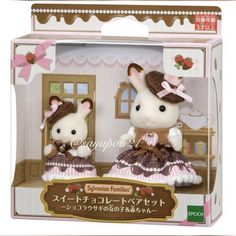 two little mice are sitting in a toy house with their heads turned to look like they are wearing dresses and hats