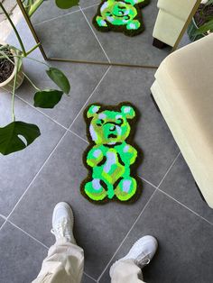 someone is standing on the floor next to two rugs that look like a teddy bear