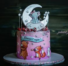 a pink cake with an elephant on top and stars around the edges, sitting on a plate