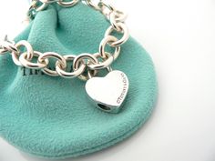 Overview:Offered for sale is a wonderful and gorgeous Tiffany & Co. Sterling Silver & "XOXO" (Hugs and Kisses) Heart Padlock Bracelet. Hanging from its bright Tiffany silver chain is a very pretty XOXO Heart Padlock charm! A classic Tiffany piece that any girl will adore! The Heart Padlock charm opens and closes, and thus allows you to wear the charm on a necklace or as part of another charm bracelet! Super cool and versatile piece! It is simple, elegant, and classic all rolled into one Luxury Valentine's Day Charm Bracelet, Luxury Charm Bracelet For Valentine's Day, Luxury Charm Bracelet With Heart Charm For Gift, Luxury Charm Bracelet With Heart Charm As A Gift, Luxury Heart Charm Bracelet As Gift, Luxury Heart Charm Bracelet For Gift, Padlock Bracelet, Heart Padlocks, Hugs Kisses