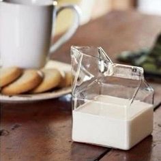 a person pouring milk into a bowl next to a plate of cookies and a glass of milk