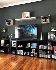 a large flat screen tv mounted to the side of a wall in a living room