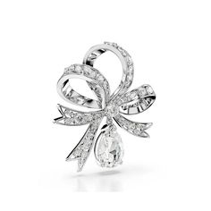 Elevate any outfit with the elegant craftsmanship of this Volta brooch. Wrapped up in a bow-like shape, the design is rhodium plated with an array of clear Swarovski zirconia set in place using the chatonnage technique. To add to the effect, there is a round Swarovski Zirconia at the center of the bow, and a separate pear-shaped crystal, which hangs beneath. An enchanting and radiant way to brighten your style. Since 1895, Swarovski has been committed to philanthropy and , continuously investing White Brilliant Cut Brooches For Wedding, White Brilliant Cut Wedding Brooches, Elegant Brilliant Cut Brooches As Gifts, Elegant Brilliant Cut Brooches For Anniversary, Elegant Diamond White Brooches For Formal Occasions, Silver Brooch With Decorative Bow, Silver Brooches With Decorative Bow, Elegant Silver Brooch With Bow, White Crystal Brooch For Formal Occasions