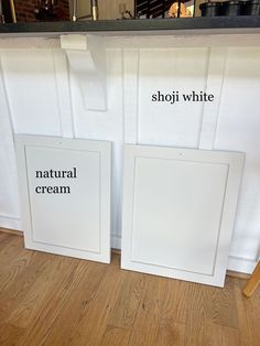 two white frames sitting on top of a hard wood floor next to each other with the words shopi white and natural cream