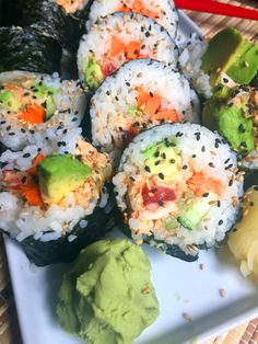 sushi rolls with avocado and other toppings on a plate