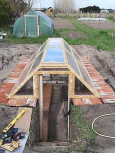 an unfinished building with a skylight on the roof and some tools in front of it