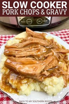 slow cooker pork chops and gravy on top of mashed potatoes