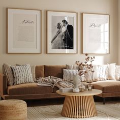 a living room with couches and pictures on the wall above them, including a coffee table