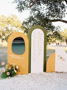 an outdoor ceremony setup with flowers on the ground and trees in the backgroud