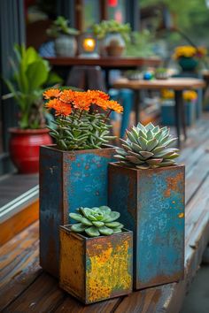 two planters with succulents are sitting on a bench