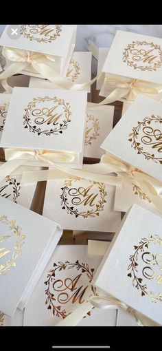 many white cards with gold foil on them