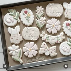 a box filled with lots of decorated cookies