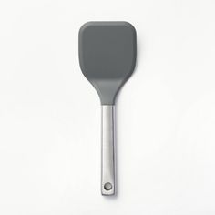 a gray spatula with a metal handle on a white surface