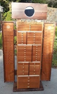 there is a large wooden cabinet with many drawers