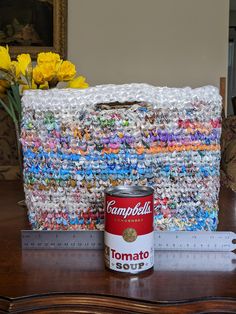 a can of soup sitting on top of a wooden table