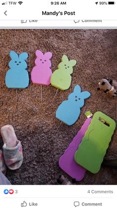 several cell phones are laying on the ground with bunny shaped stickers attached to them