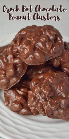 chocolate peanut clusters on a white plate with the words crock pot chocolate peanut clusters