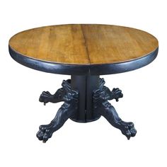 a wooden table with metal legs and an ornate design on the top, against a white background