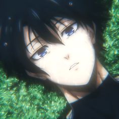 an anime character laying in the grass with his eyes open and one eye half closed