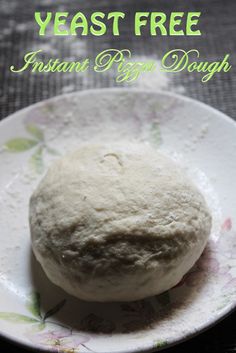 a white plate topped with a ball of dough on top of a black tablecloth