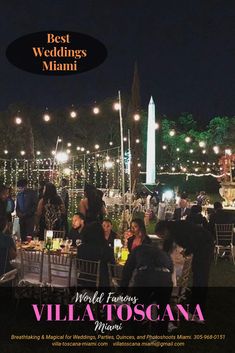 a group of people sitting around a table with lights on the ceiling and in front of them